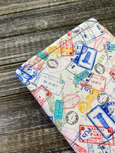 Load image into Gallery viewer, Globetrotter Travel Stamps Padded Book Sleeve | BookGoodies | Book Pocket | Protective Book Bag | Book Pouch | Bookish Nerd Gift

